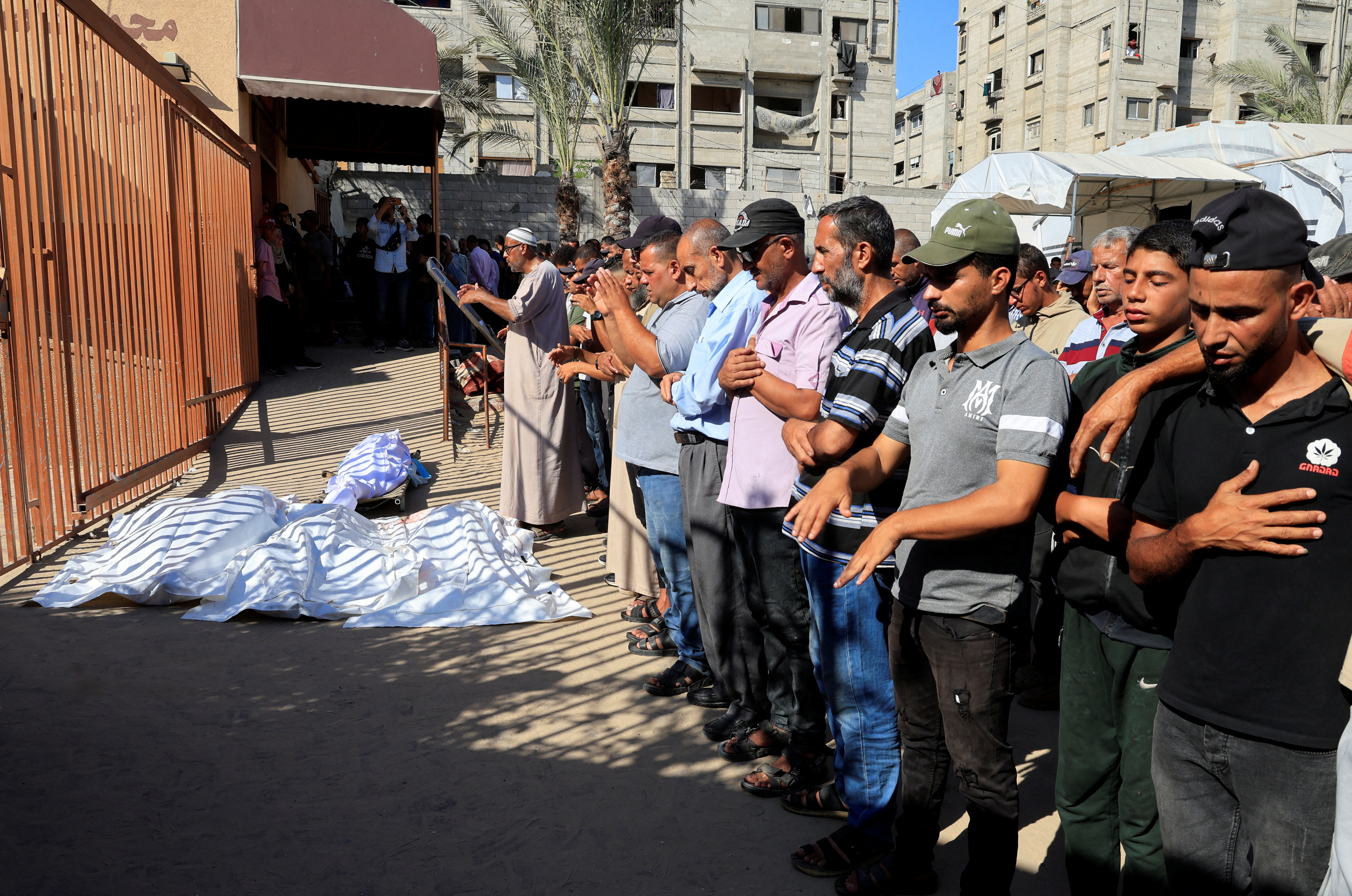cover 21 Palestinians killed by Israeli gunfire and airstrikes