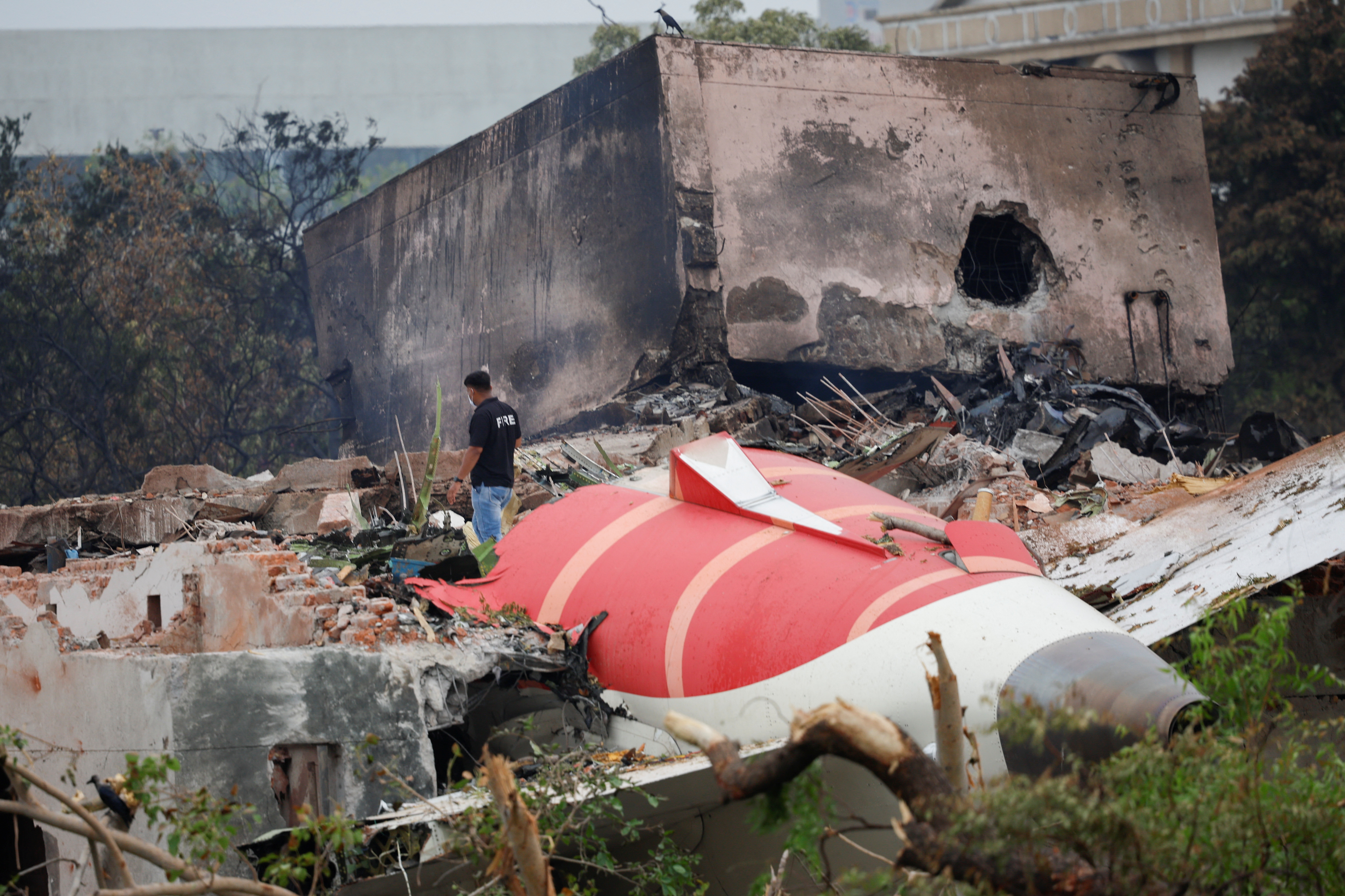 image Rescuers scour buildings after Air India plane crash kills over 240