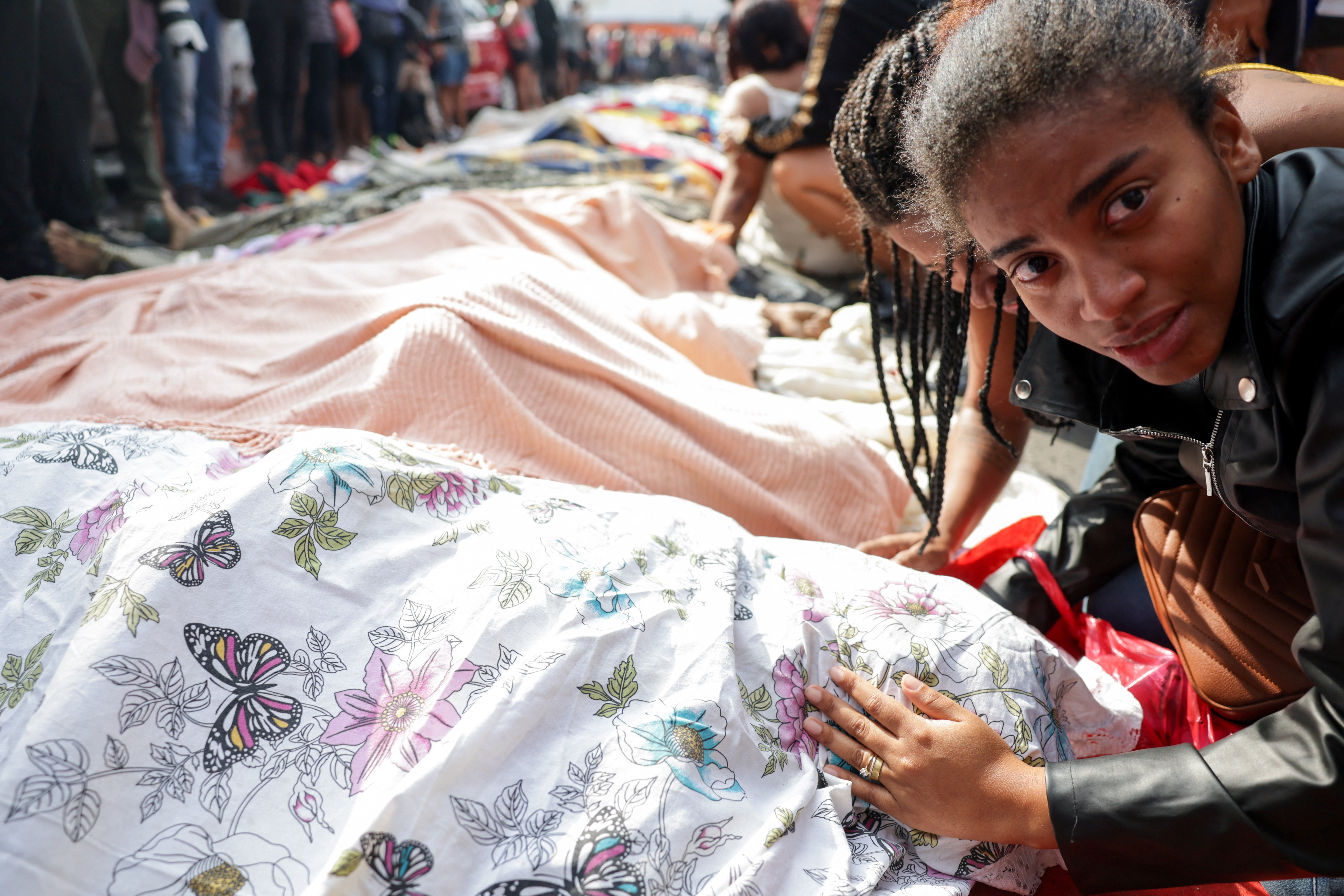 cover Corpses line Rio street, pushing death toll from police raids to 132