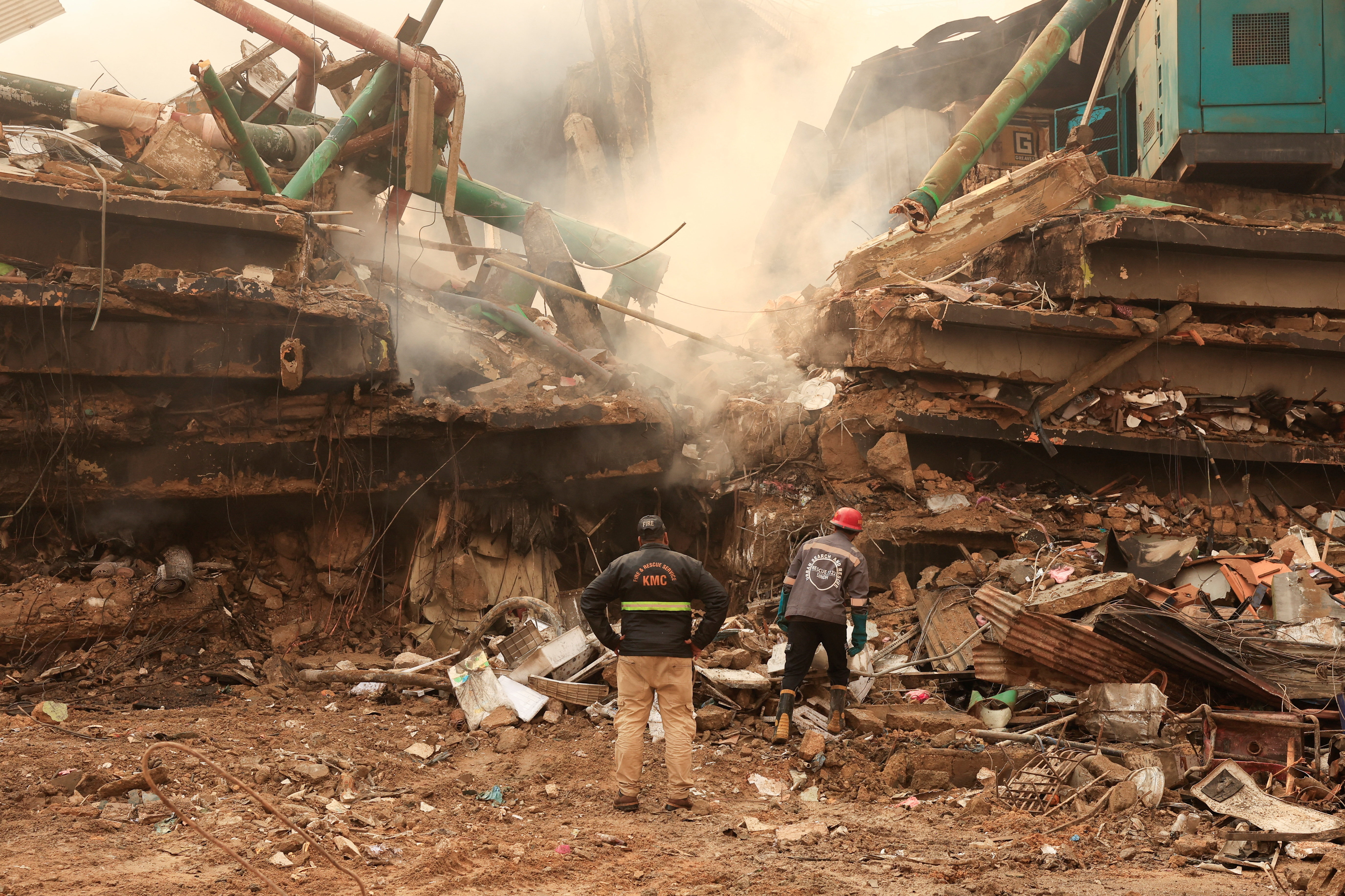 cover Dozens missing after massive Karachi mall fire, 19 killed