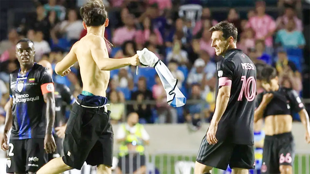 cover Messi knocked down as security guard subdues pitch invader