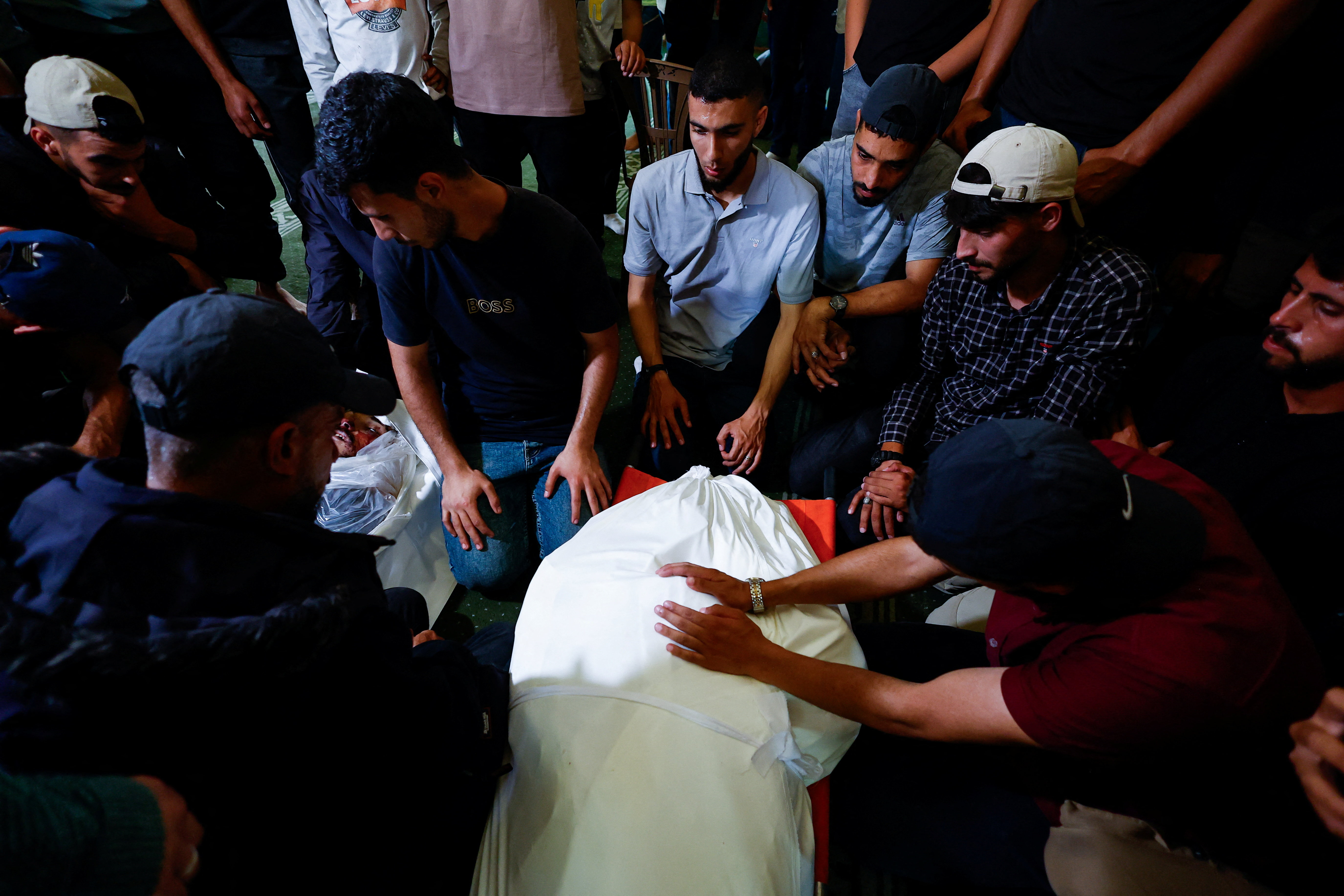 cover Palestinians mourn slain Hamas militant chief as Israel escalates Gaza attacks
