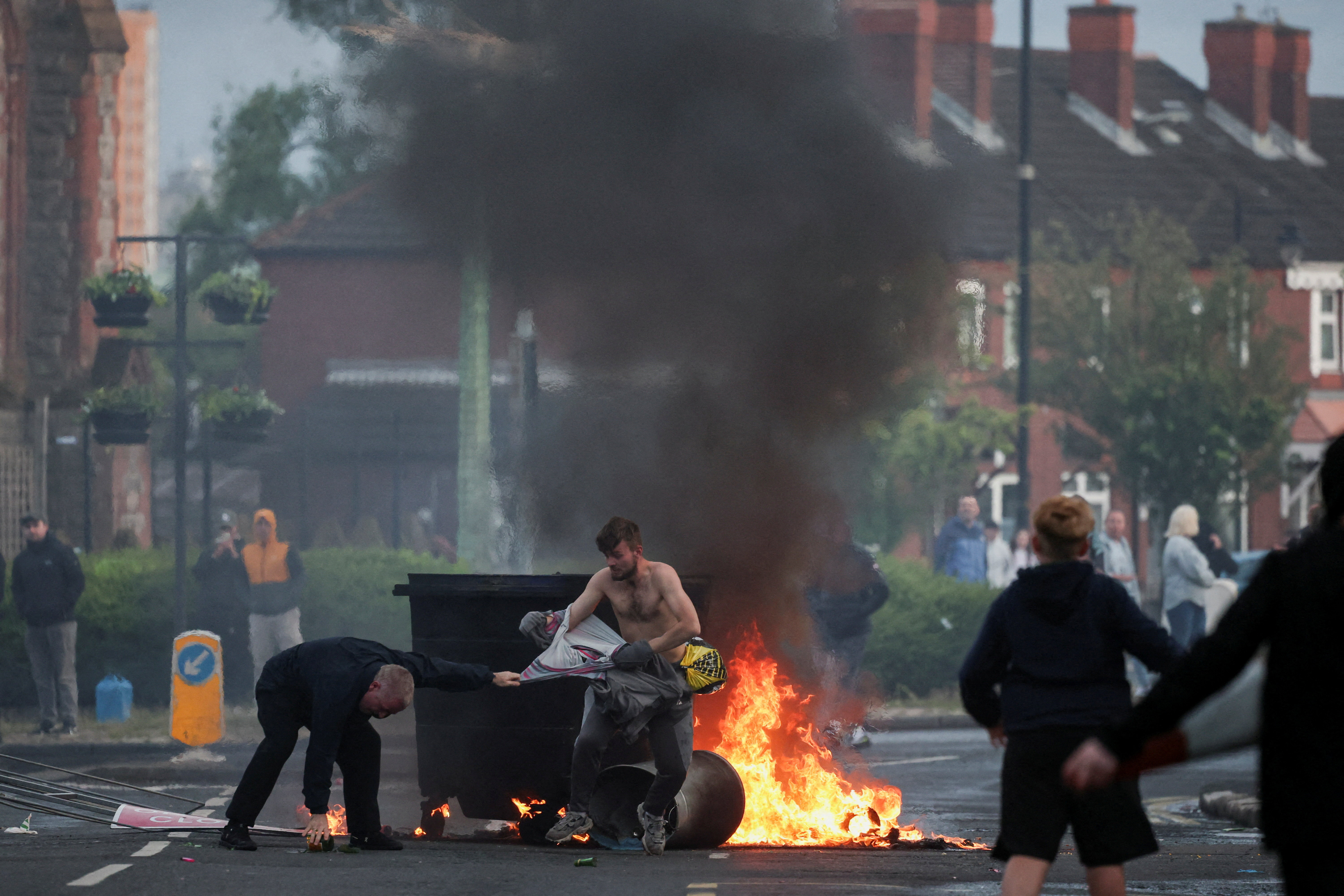 cover Belfast knife attack sparks anti-immigrant protests, vehicles set alight
