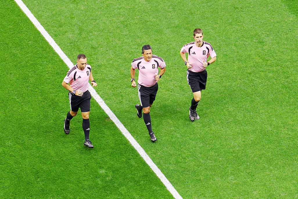 cover The hidden runners: referees keep pace with players and pressure