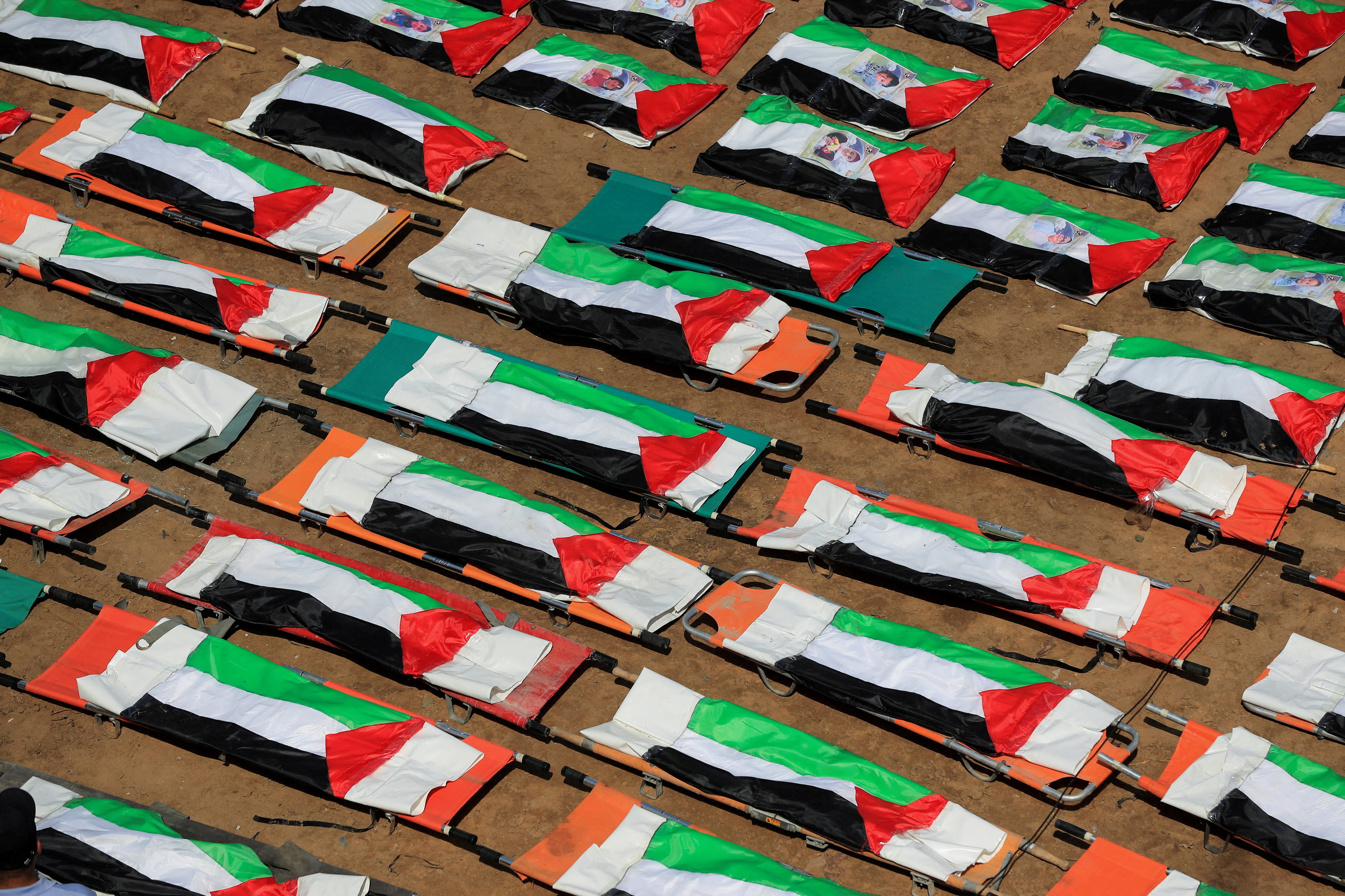 cover Gazans bury nearly a whole clan found in rubble in mass funeral for 112