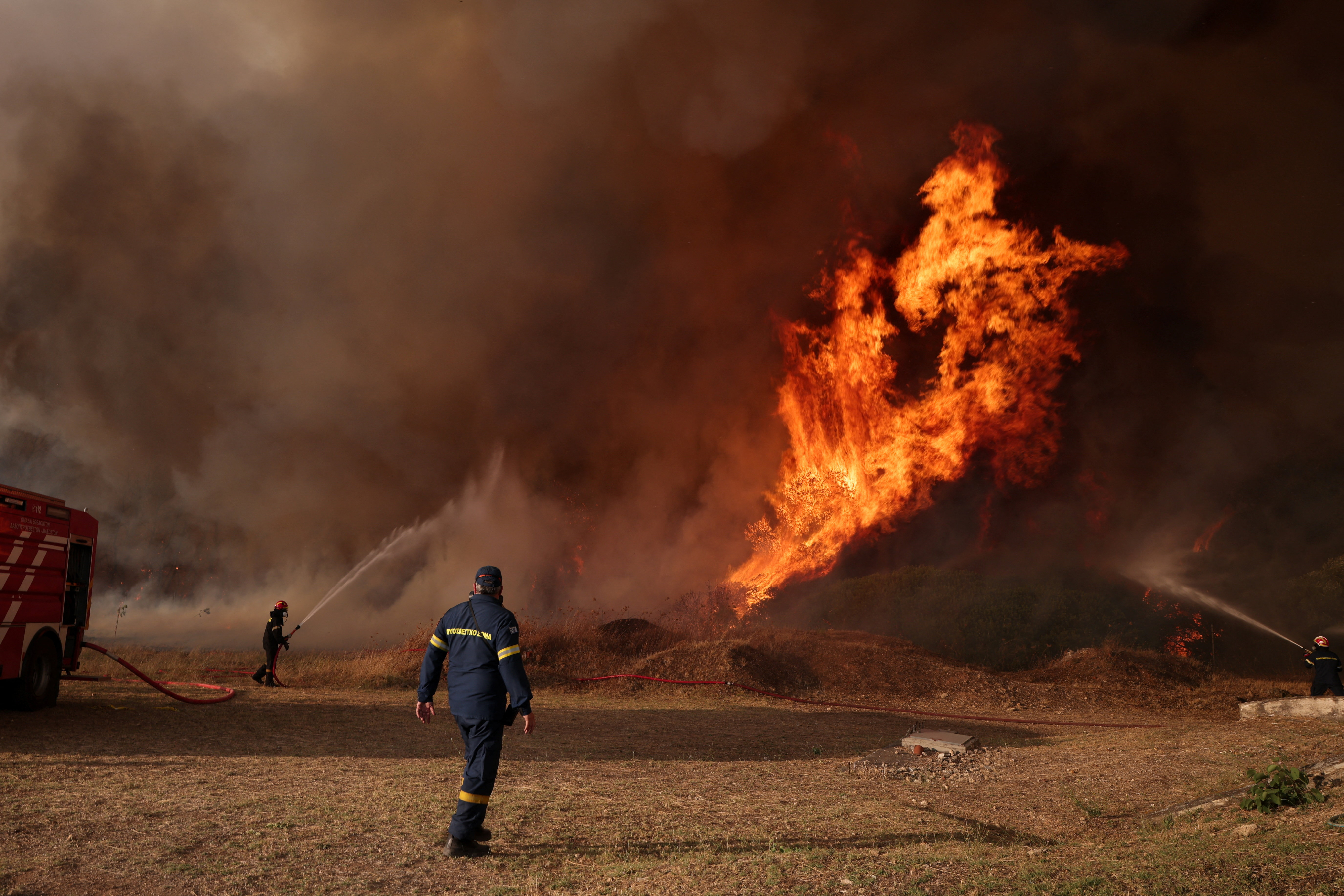cover Firefighters battle through the night as Greek wildfire scorches more than 130 square kilometres