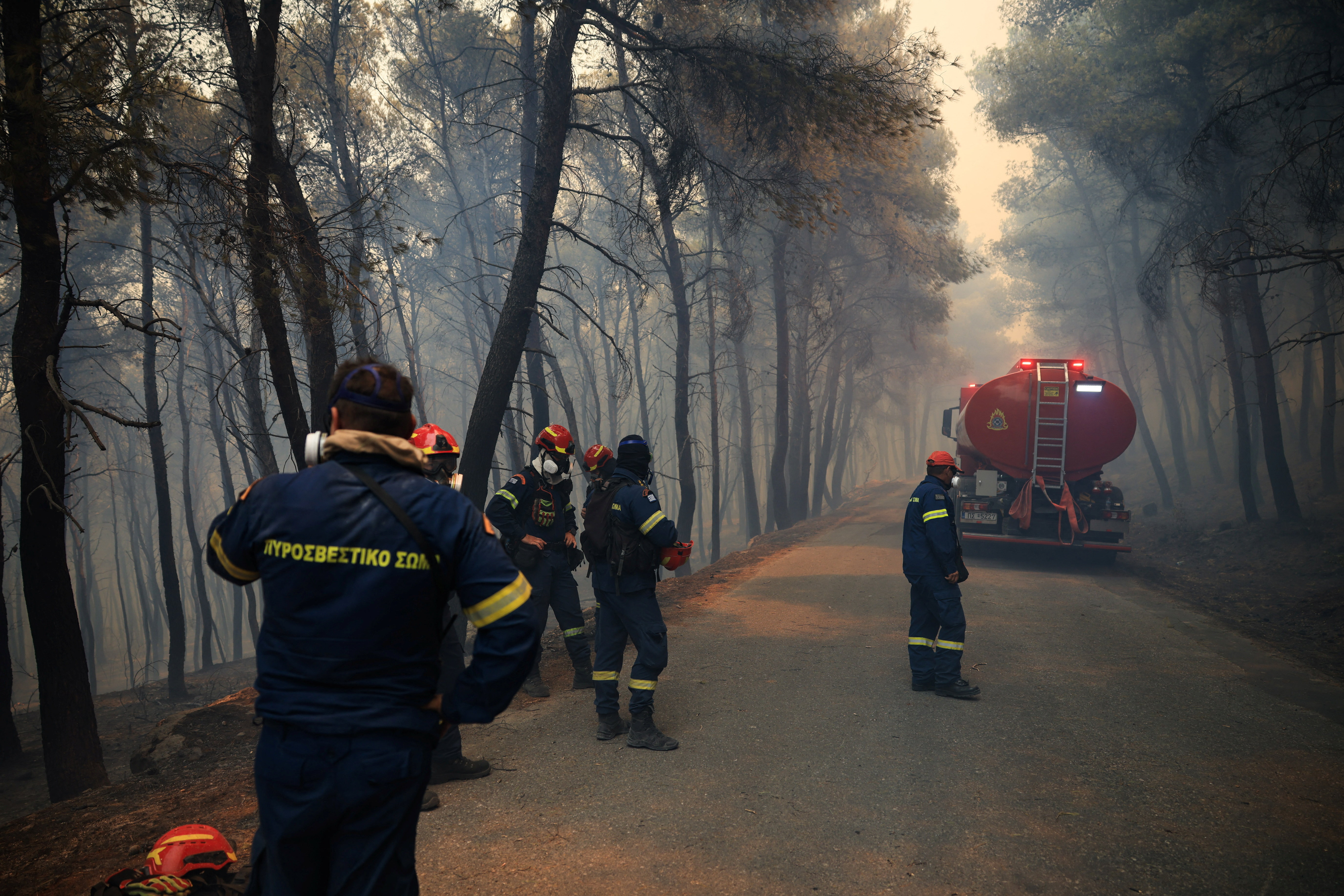 cover Wildfires rage in Greece as firefighters continue battle in France and Spain